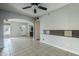 Spacious living area with tile flooring, a ceiling fan, and large windows for natural light at 2124 E Osborn Rd, Phoenix, AZ 85016