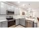 Modern kitchen with gray cabinets, white quartz countertops, and stainless steel appliances at 300 N Gila Springs Blvd # 181, Chandler, AZ 85226