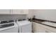 Bright laundry room, features washer, dryer, and cabinets at 17986 W Fulton St, Goodyear, AZ 85338