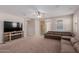 Living room with a fireplace and large TV at 17986 W Fulton St, Goodyear, AZ 85338