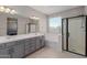 Bathroom boasts a double vanity, large mirror, and a walk-in shower at 17986 W Fulton St, Goodyear, AZ 85338