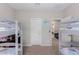 Bedroom with bunk beds and view of living area at 17986 W Fulton St, Goodyear, AZ 85338