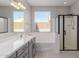 Spa-like bathroom with a soaking tub, shower, and double vanity at 17986 W Fulton St, Goodyear, AZ 85338