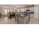 Modern kitchen with large island and stainless steel appliances at 17986 W Fulton St, Goodyear, AZ 85338