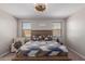 Spacious bedroom with a large bed, comfortable chair, and neutral decor at 17986 W Fulton St, Goodyear, AZ 85338