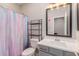 Bathroom with rainbow shower curtain at 17986 W Fulton St, Goodyear, AZ 85338