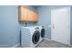 Laundry room with washer, dryer and cabinets at 17621 N Eagle Crest Dr, Surprise, AZ 85374