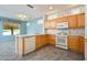 Kitchen with wood cabinets, tile floor, and island at 17621 N Eagle Crest Dr, Surprise, AZ 85374