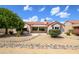 Back exterior of charming house with patio and desert landscaping at 17621 N Eagle Crest Dr, Surprise, AZ 85374