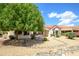 Landscaped backyard with patio and mature tree at 17621 N Eagle Crest Dr, Surprise, AZ 85374