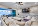 Living area with sectional sofa, backyard access, and a rustic accent wall at 4145 S Zephyr --, Mesa, AZ 85212