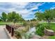Tranquil pond with a footbridge and lush landscaping at 4145 S Zephyr --, Mesa, AZ 85212