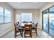 Bright dining room with round table and six chairs, near sliding door to patio at 4145 S Zephyr --, Mesa, AZ 85212