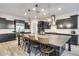 Modern kitchen boasts a large island, stainless steel appliances, and dark cabinetry at 4145 S Zephyr --, Mesa, AZ 85212