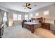 Spacious main bedroom with king-size bed, large windows, and carpeted floor at 4145 S Zephyr --, Mesa, AZ 85212