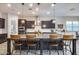 Large kitchen island with seating, dark cabinetry, and granite countertops at 4145 S Zephyr --, Mesa, AZ 85212