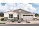 One-story house with a two-car garage and desert landscaping at 11949 W Parkway Ln, Avondale, AZ 85323