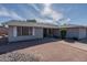 Gray one-story house with a brick facade at 4841 E Paiute St, Phoenix, AZ 85044