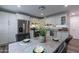 Well-lit kitchen with white cabinets, granite counters, and a dining area at 6514 N 85Th Pl, Scottsdale, AZ 85250