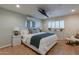 Main bedroom with a king bed, a large window, and a ceiling mounted TV at 6514 N 85Th Pl, Scottsdale, AZ 85250
