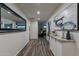 Long hallway with wood-look flooring and a large mirror at 6514 N 85Th Pl, Scottsdale, AZ 85250