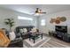 Spacious living room with a comfortable leather sofa and ceiling fan at 6514 N 85Th Pl, Scottsdale, AZ 85250