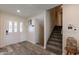 Inviting entryway with stairs, wood-look floors, and coat rack at 6514 N 85Th Pl, Scottsdale, AZ 85250