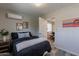 Cozy bedroom with a double bed, nightstand, and adjacent office at 6514 N 85Th Pl, Scottsdale, AZ 85250