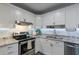 Modern kitchen featuring white cabinets, granite countertops, and stainless steel appliances at 6514 N 85Th Pl, Scottsdale, AZ 85250