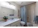 Clean bathroom with a white vanity, shower/tub combo and updated fixtures at 6514 N 85Th Pl, Scottsdale, AZ 85250