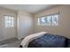 Bright bedroom with a queen bed, closet, and exterior access at 6514 N 85Th Pl, Scottsdale, AZ 85250