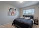Cozy bedroom featuring a full bed, artwork, and window at 6514 N 85Th Pl, Scottsdale, AZ 85250