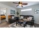Relaxing living room featuring leather seating, a coffee table, and a ceiling fan at 6514 N 85Th Pl, Scottsdale, AZ 85250
