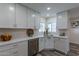 Modern kitchen with white cabinets and stainless steel appliances at 6514 N 85Th Pl, Scottsdale, AZ 85250