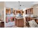 Kitchen with wood cabinets, granite counters, and island at 3718 S 379Th Ave, Tonopah, AZ 85354