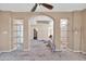 Living room with high ceilings and built-in shelving needs renovation at 3718 S 379Th Ave, Tonopah, AZ 85354
