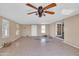 Large living room with ceiling fan and tiled floor at 3718 S 379Th Ave, Tonopah, AZ 85354