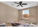 Simple bedroom with a window and ceiling fan needing renovation at 3718 S 379Th Ave, Tonopah, AZ 85354