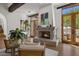 Cozy sitting area with fireplace and French doors leading to the outdoors at 5201 N Saddle Rock Dr, Phoenix, AZ 85018