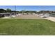 Community cornhole area with grassy lawn and benches at 18147 W Ida Ln, Surprise, AZ 85387
