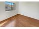 Bright bedroom with wood-look flooring and large window at 2970 N Oregon St # 10, Chandler, AZ 85225