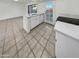Bright kitchen features white cabinets, quartz countertops, and tile floors at 2970 N Oregon St # 10, Chandler, AZ 85225