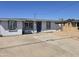 Single story home with blue door and landscaped yard at 206 N 5Th St, Avondale, AZ 85323
