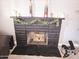 Brick fireplace with decorative mantle and greenery at 206 N 5Th St, Avondale, AZ 85323