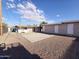 Large backyard with covered patio, storage shed, and paved patio area at 206 N 5Th St, Avondale, AZ 85323