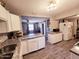 Updated kitchen features granite countertops, white cabinets, and stainless steel appliances at 206 N 5Th St, Avondale, AZ 85323