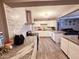 Bright kitchen with granite countertops, white cabinets, and a tile backsplash at 206 N 5Th St, Avondale, AZ 85323