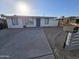Single story home with blue door and landscaped yard at 206 N 5Th St, Avondale, AZ 85323