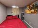 Small bedroom with a red bedspread at 206 N 5Th St, Avondale, AZ 85323