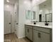 Bathroom with double vanity, gray cabinets, and a large mirror at 5541 W Summerside Rd, Laveen, AZ 85339